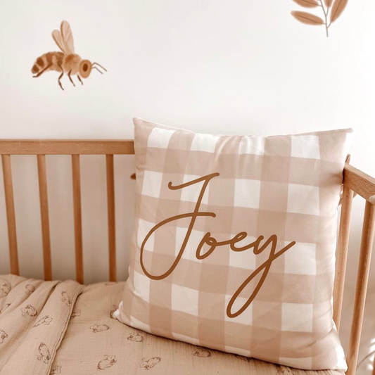 Personalised neutral gingham cushion cover styled in nursery