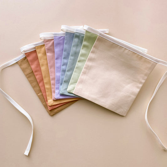 Soft rainbow bunting. Pastel square flag bunting. Kids nursery decor. Soft pastel kids bedroom styling. Pastel rainbow nursery. Modern kids nursery wall decor. Calm colourful playroom decor. Kids rental friendly decor. Minimalist rainbow bunting. Timeless nursery wall flags. Nursery garland. Rainbow garland. Gender neutral wall decor. Colourful wall garland. Colourful kids playroom decor.