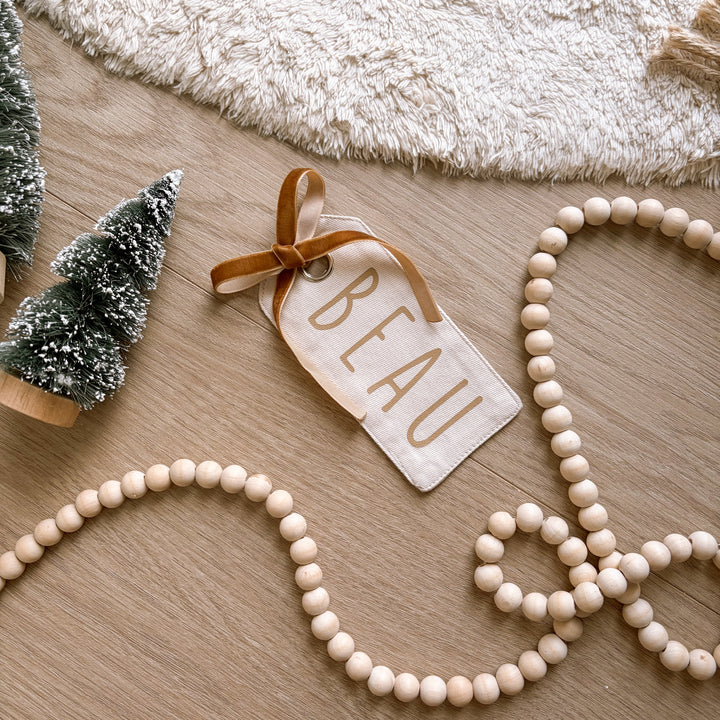 personalised Christmas gift tag, reusable canvas gift tag, personalised gift tag, Christmas present tag, fabric gift tag, canvas name tag, personalised name tag, reusable present tag, Christmas gift wrapping, neutral Christmas decor, warm sand gift tag, beige Christmas tag, vintage Christmas decor, kids Christmas gift tag, custom Christmas tag, personalised Christmas decor, sustainable gift wrapping, Christmas keepsake, stocking tag, Santa sack tag, Australian Christmas gifts