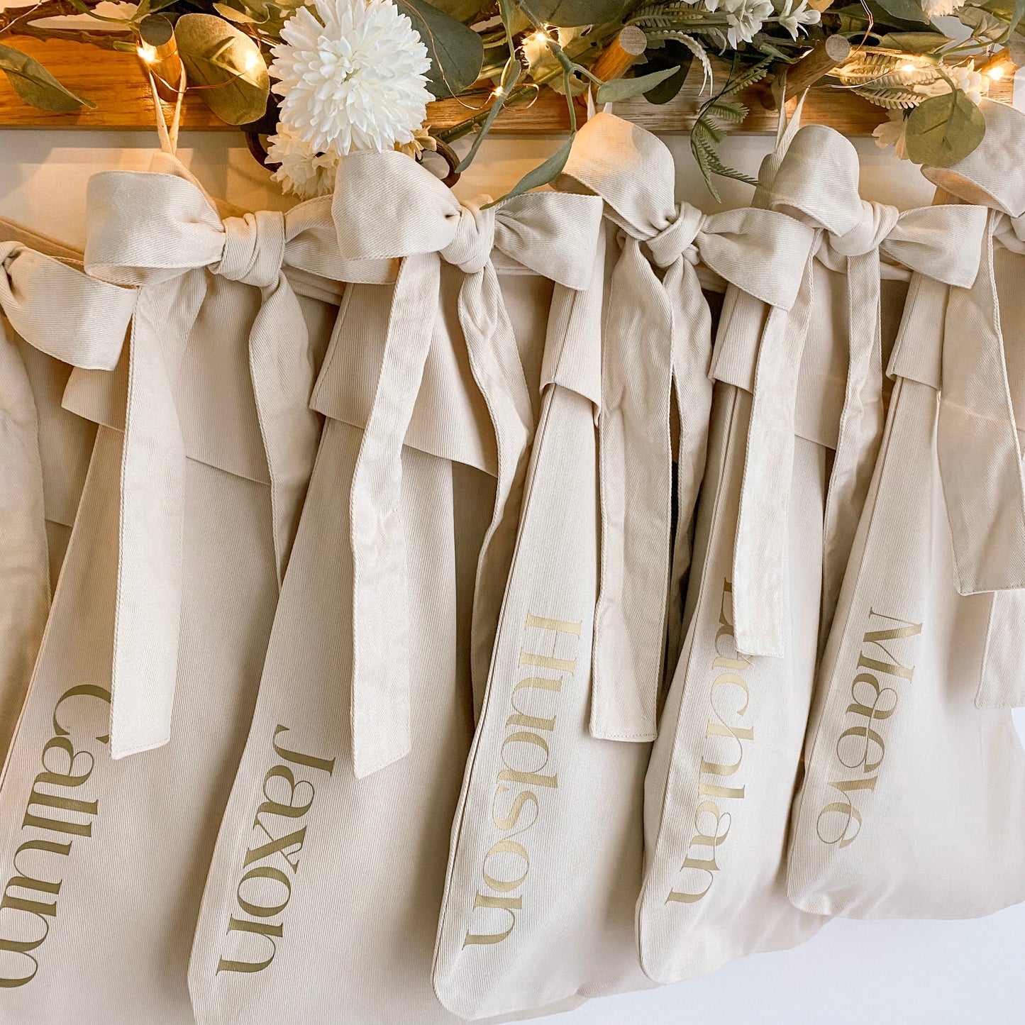 Personalised Christmas canvas bow stocking. Custom Christmas neutral stocking with bow. Minimalist bow Christmas stocking. Bow Name Christmas stocking. Personalised beige stocking with bow. Personalised cotton neutral bow stocking.