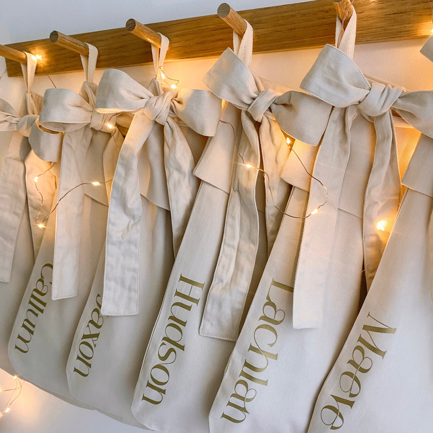Personalised Christmas canvas bow stocking. Custom Christmas neutral stocking with bow. Minimalist bow Christmas stocking. Bow Name Christmas stocking. Personalised beige stocking with bow. Personalised cotton neutral bow stocking.