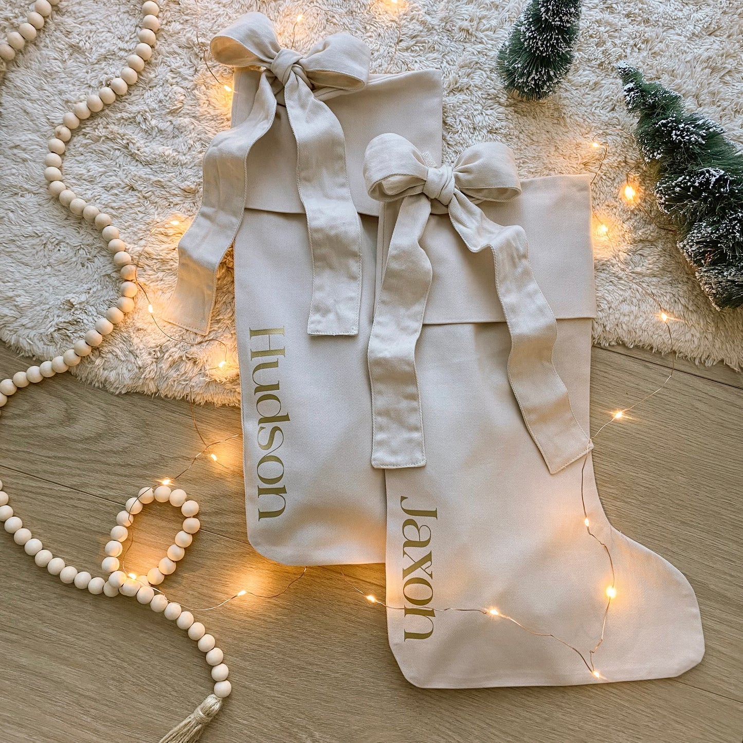 Personalised Christmas canvas bow stocking. Custom Christmas neutral stocking with bow. Minimalist bow Christmas stocking. Bow Name Christmas stocking. Personalised beige stocking with bow. Personalised cotton neutral bow stocking.