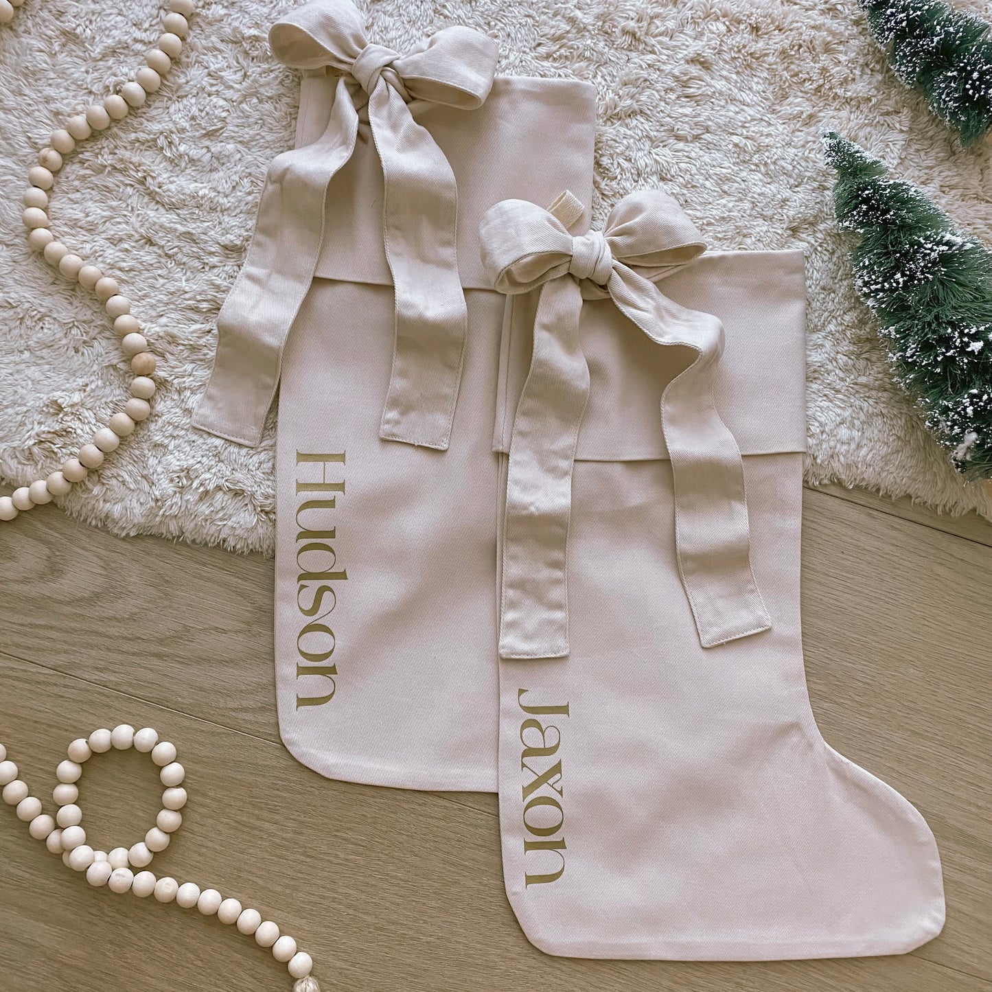 Personalised Christmas canvas bow stocking. Custom Christmas neutral stocking with bow. Minimalist bow Christmas stocking. Bow Name Christmas stocking. Personalised beige stocking with bow. Personalised cotton neutral bow stocking.