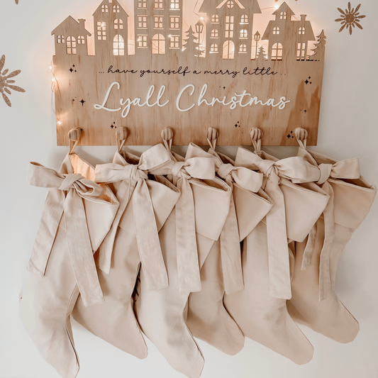 Personalised Christmas canvas bow stocking. Custom Christmas neutral stocking with bow. Minimalist bow Christmas stocking. Bow Name Christmas stocking. Personalised beige stocking with bow. Personalised cotton neutral bow stocking.