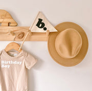 Neutral personalised pennant flag, Natural initial pennant, Personalised kids room decor, Personalised nursery decor, Alphabet initial flag, Neutral nursery decor, Beige kids bedroom decor, Natural kids room decor, Gender-neutral nursery decor, Minimal nursery accessories, Neutral personalised decor, Kids initial decor, Fabric pennant flag, Rental-friendly kids decor, Australian kids decor, Hello Saturday Kids Decor