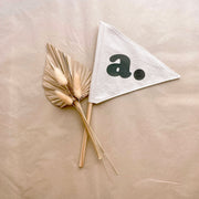 Neutral personalised pennant flag, Natural initial pennant, Personalised kids room decor, Personalised nursery decor, Alphabet initial flag, Neutral nursery decor, Beige kids bedroom decor, Natural kids room decor, Gender-neutral nursery decor, Minimal nursery accessories, Neutral personalised decor, Kids initial decor, Fabric pennant flag, Rental-friendly kids decor, Australian kids decor, Hello Saturday Kids Decor