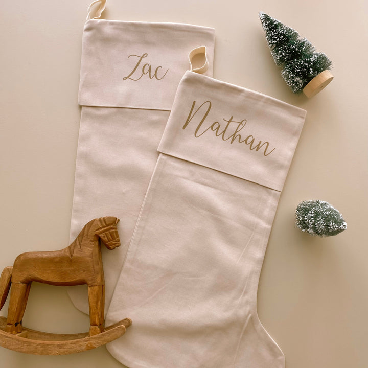 personalised Christmas stocking, warm sand Christmas stocking, beige Christmas stocking, natural Christmas stocking, neutral Christmas stocking, classic Christmas stocking, personalised kids stocking, personalised family stocking, canvas Christmas stocking, cotton Christmas stocking, custom name stocking, neutral Christmas decor, natural Christmas decor, coastal Christmas decor, Christmas keepsake, reusable Christmas stocking, children’s Christmas stocking, Australian Christmas decor