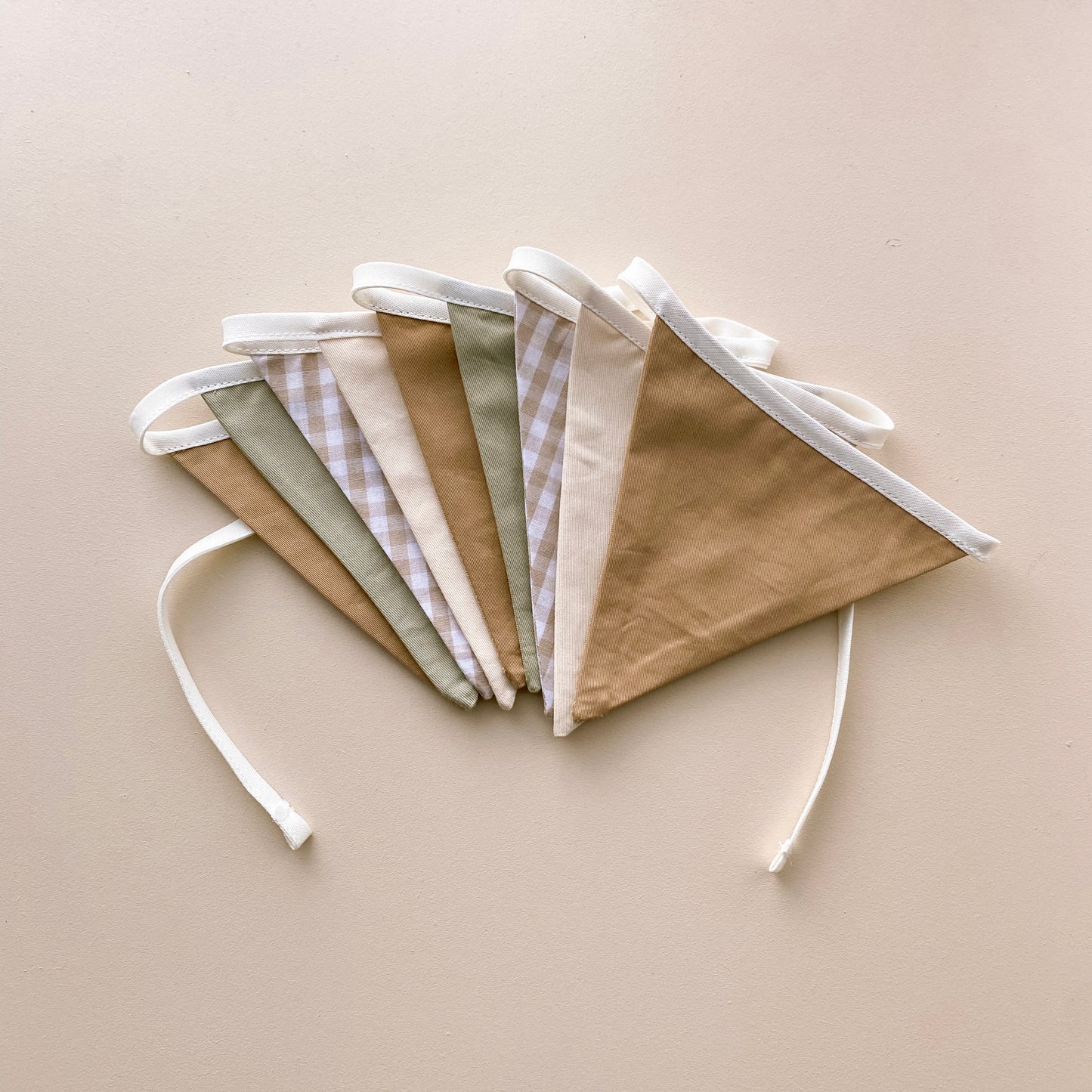 Vintage triangle bunting. Boys nursery decor. Neutral boys bedroom styling. Green and beige bunting flags. Gingham nursery bunting. Retro boys room decor. Earthy nursery wall decor. Kids rental friendly decor. Classic boys nursery inspo. Timeless kids room bunting.