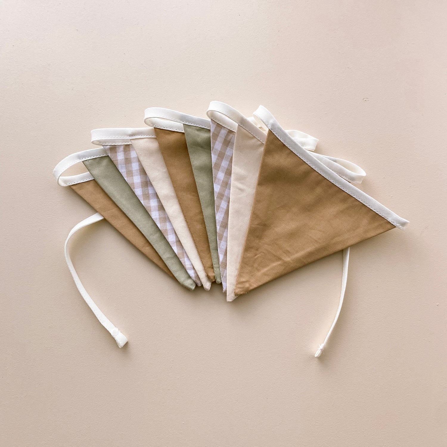 Vintage triangle bunting. Boys nursery decor. Neutral boys bedroom styling. Green and beige bunting flags. Gingham nursery bunting. Retro boys room decor. Earthy nursery wall decor. Kids rental friendly decor. Classic boys nursery inspo. Timeless kids room bunting.
