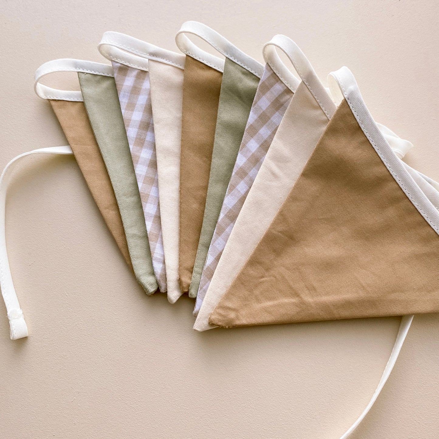 Vintage triangle bunting. Boys nursery decor. Neutral boys bedroom styling. Green and beige bunting flags. Gingham nursery bunting. Retro boys room decor. Earthy nursery wall decor. Kids rental friendly decor. Classic boys nursery inspo. Timeless kids room bunting.