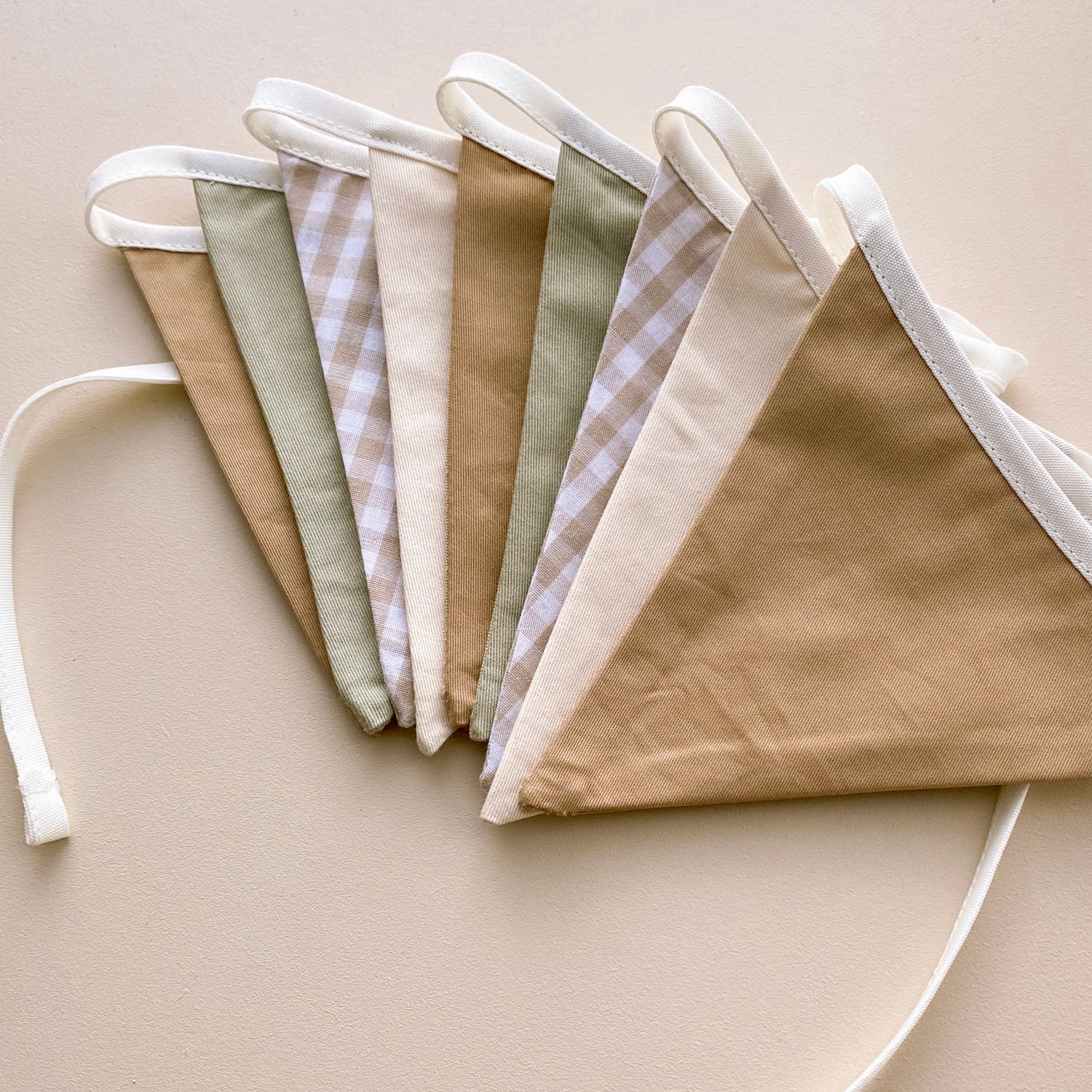 Vintage triangle bunting. Boys nursery decor. Neutral boys bedroom styling. Green and beige bunting flags. Gingham nursery bunting. Retro boys room decor. Earthy nursery wall decor. Kids rental friendly decor. Classic boys nursery inspo. Timeless kids room bunting.