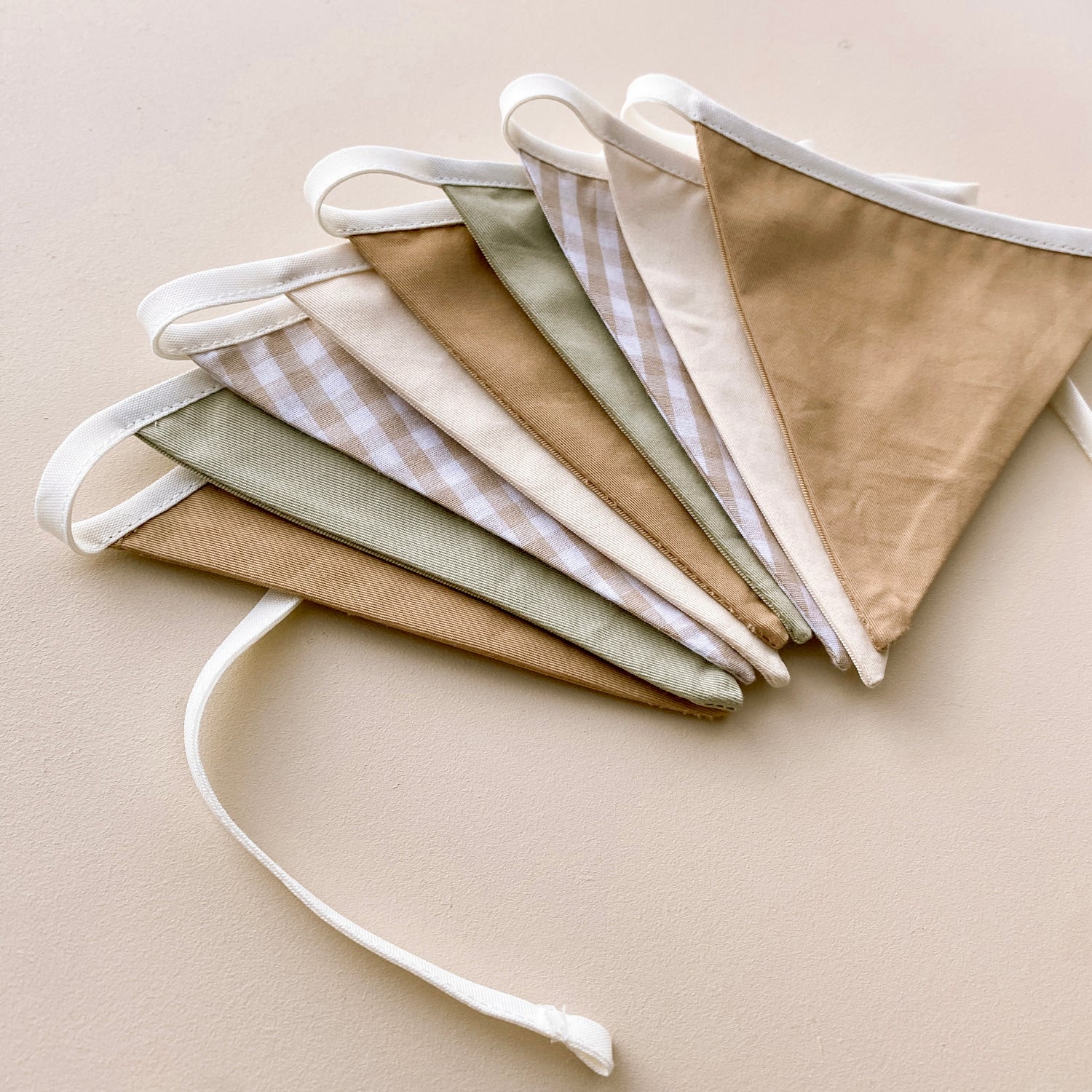 Vintage triangle bunting. Boys nursery decor. Neutral boys bedroom styling. Green and beige bunting flags. Gingham nursery bunting. Retro boys room decor. Earthy nursery wall decor. Kids rental friendly decor. Classic boys nursery inspo. Timeless kids room bunting.