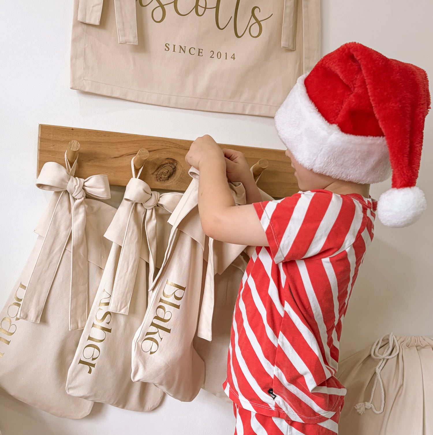personalised bow Christmas stocking, warm sand Christmas stocking, beige bow stocking, neutral Christmas stocking, personalised Christmas stocking, removable bow stocking, oversized bow stocking, canvas Christmas stocking, cotton Christmas stocking, custom name stocking, personalised kids stocking, neutral Christmas decor, natural Christmas decor, cottagecore Christmas decor, vintage Christmas stocking, Christmas keepsake, reusable Christmas stocking, Australian Christmas decor