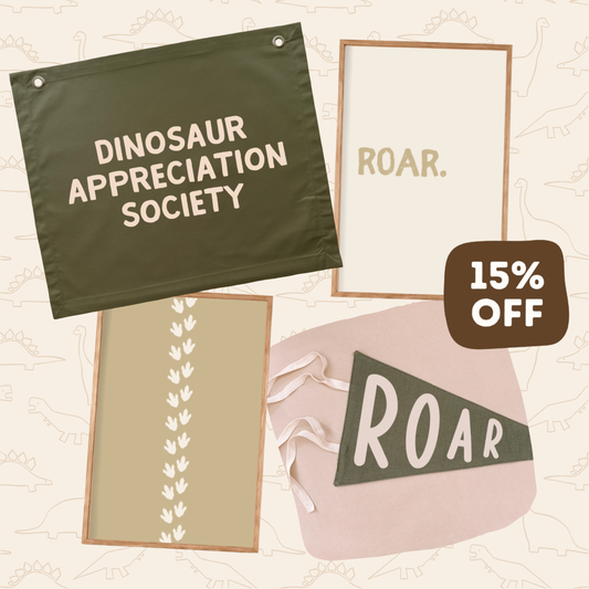 Four framed wall art prints and a pennant-style sign arranged on a beige background with a faint dinosaur outline pattern. The top-left piece is dark olive green with cream text reading 'DINOSAUR APPRECIATION SOCIETY.