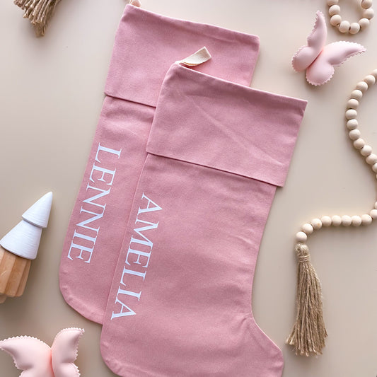 personalised Christmas stocking, pink Christmas stocking, personalised pink stocking, classic Christmas stocking, personalised kids stocking, personalised family stocking, canvas Christmas stocking, cotton Christmas stocking, custom name stocking, pink Christmas decor, pastel Christmas decor, colourful Christmas decor, whimsical Christmas decor, Christmas keepsake, reusable Christmas stocking, children’s Christmas stocking, girls Christmas stocking, Australian Christmas decor