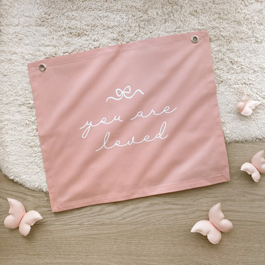 You Are Loved banner. Girls bedroom decor. Affirmation wall decor. Girls nursery sign. Dainty playroom styling. Pretty girls room wall hanging. Kids rental friendly decor. Girls bedroom wall banner. Playroom wall decor. Kids bedroom inspo. Kids playroom ideas.