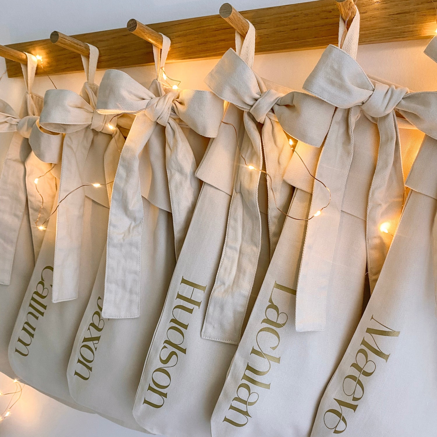 Personalised Christmas canvas bow stocking. Custom Christmas neutral stocking with bow. Minimalist bow Christmas stocking. Bow Name Christmas stocking. Personalised beige stocking with bow. Personalised cotton neutral bow stocking.