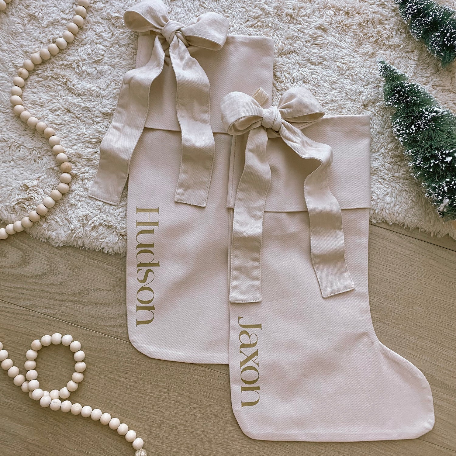 Personalised Christmas canvas bow stocking. Custom Christmas neutral stocking with bow. Minimalist bow Christmas stocking. Bow Name Christmas stocking. Personalised beige stocking with bow. Personalised cotton neutral bow stocking.