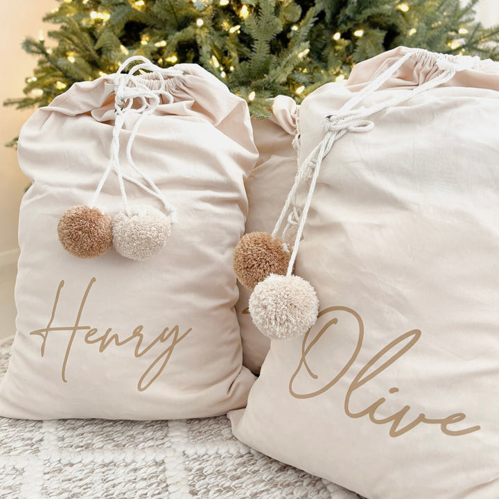 Vintage Christmas sack. Vintage Santa sack. Personalised pom Pom Christmas canvas Santa sack. Custom Christmas neutral Pom Pom present sack. Minimalist pom Pom Christmas sack. Cottagecore Name Christmas Santa sack. Personalised beige sack with Pom Poms. Personalised Cottagecore neutral santa sack. 
