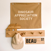 Neutral tan Dinosaur appreciation wall banner. Tan Dino banner. Boys neutral dinosaur bedroom styling. Boys neutral dinosaur bedroom wall decor. Boys bedroom Dino wall banner. Boys Dino themed wall decor. Boys dinosaur bedroom. Boys tan Dino bedroom decor ideas. 7 year old bedroom ideas. 10 year old bedroom ideas. 12 year old bedroom ideas. Neutral Dino nursery decor. Dinosaur nursery banner. 